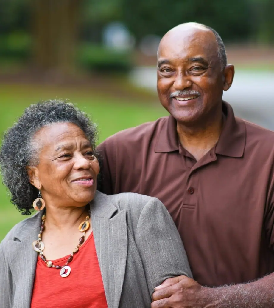 A retired couple laughing together at home