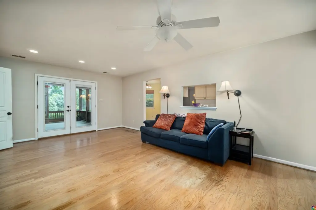 The family room, with hardwood floors and French doors to the screened porch